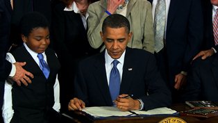 Obama signing the Obamacare law